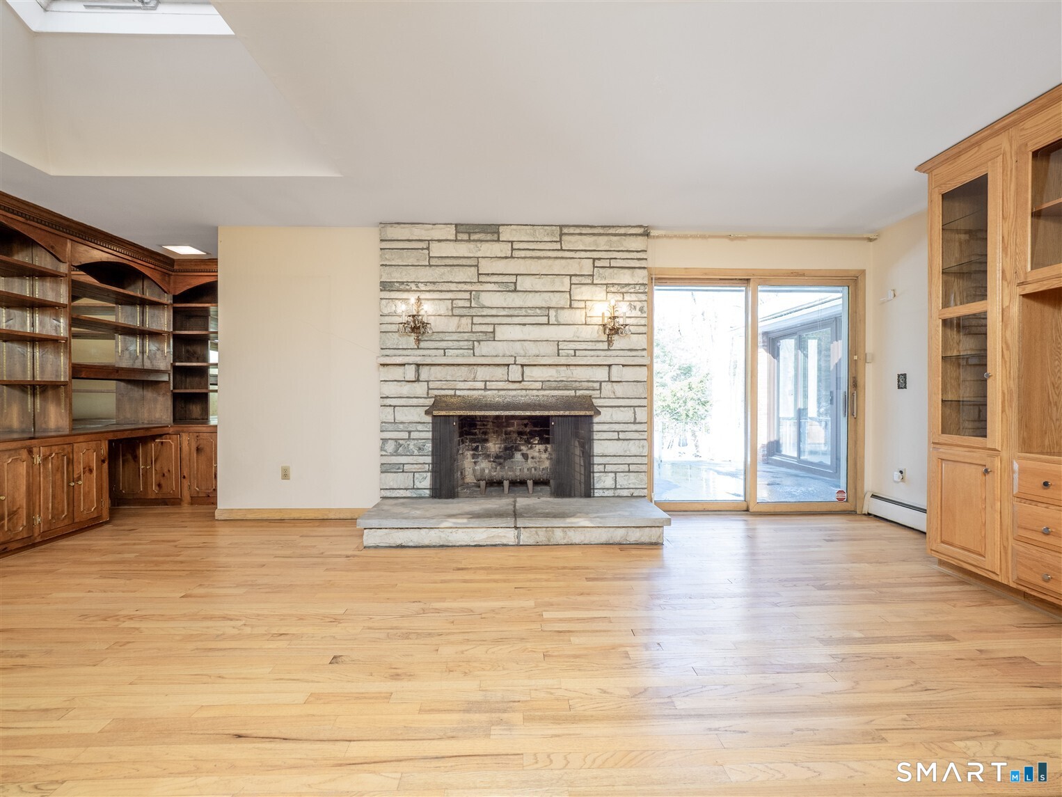 78 Ruscoe Road Wilton, CT 06897 - Photo 25 of 40 a view of a livingroom with wooden floor and a fireplace