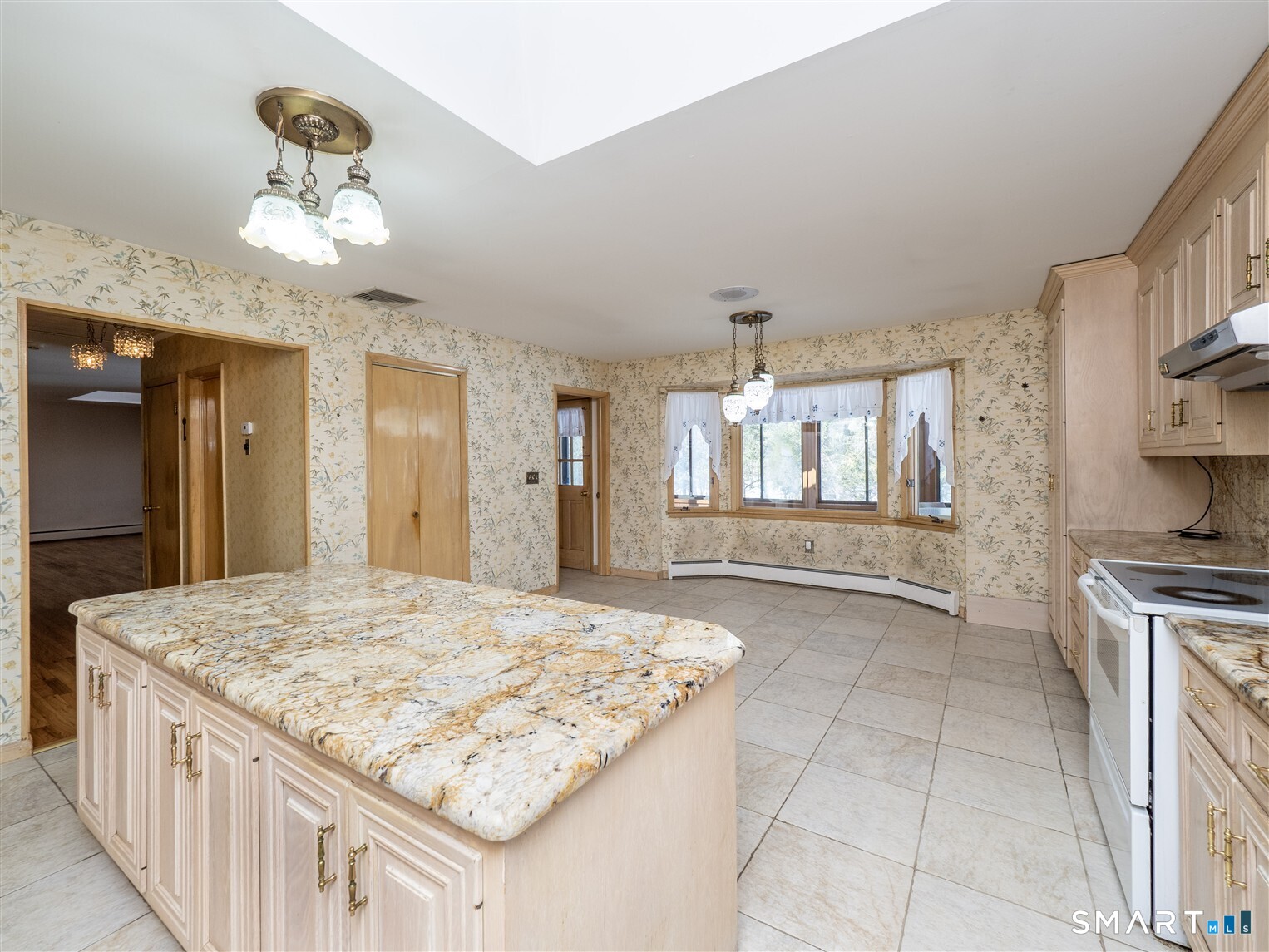 78 Ruscoe Road Wilton, CT 06897 - Photo 27 of 40 a kitchen with kitchen island granite countertop a stove and a sink