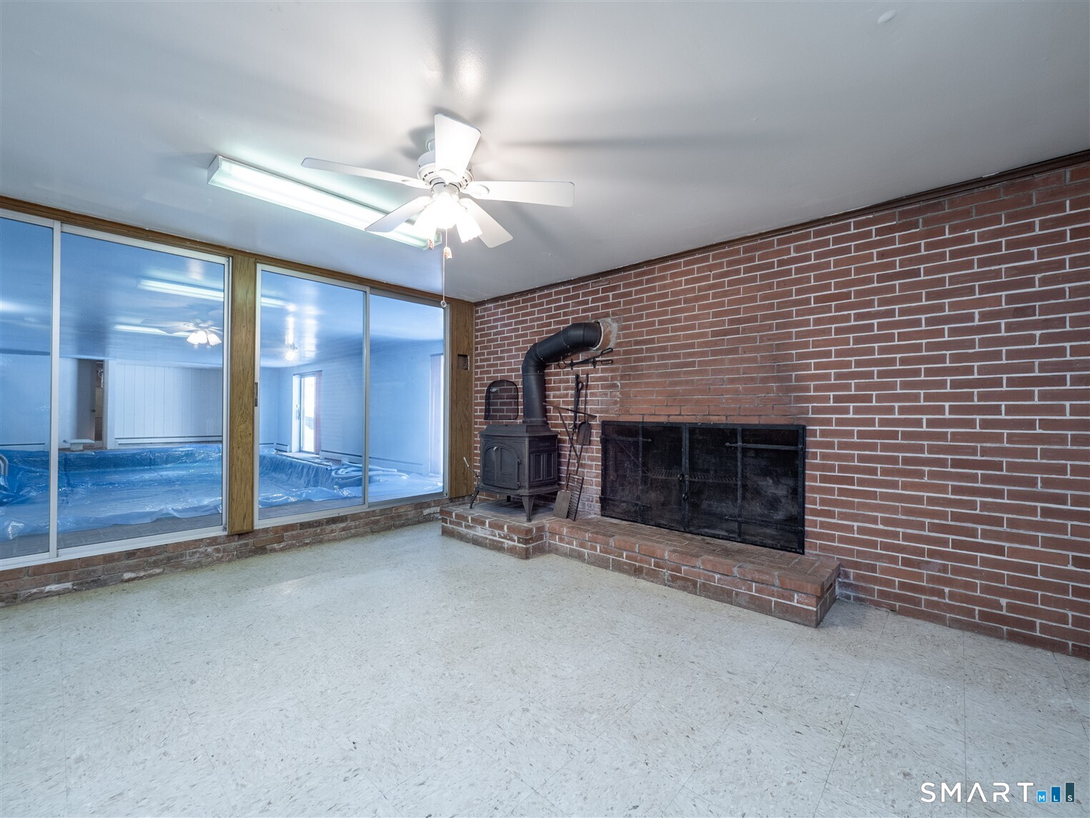 78 Ruscoe Road Wilton, CT 06897 - Photo 34 of 40 an empty room with fireplace and fan