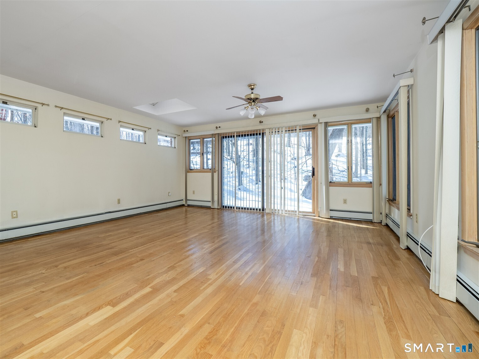 78 Ruscoe Road Wilton, CT 06897 - Photo 9 of 40 a view of an empty room with a window and wooden floor
