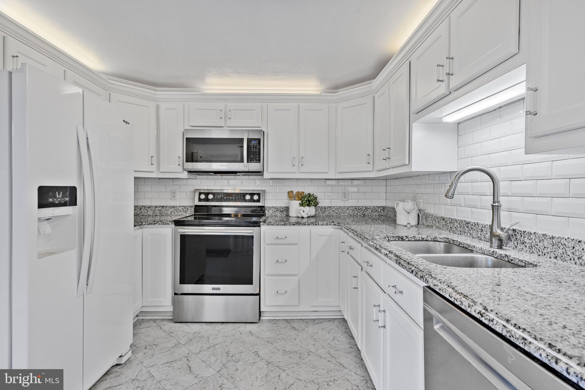 21315 Ridge Road Freeland, MD 21053 - Photo 18 of 69 a kitchen with granite countertop a stove sink and a microwave