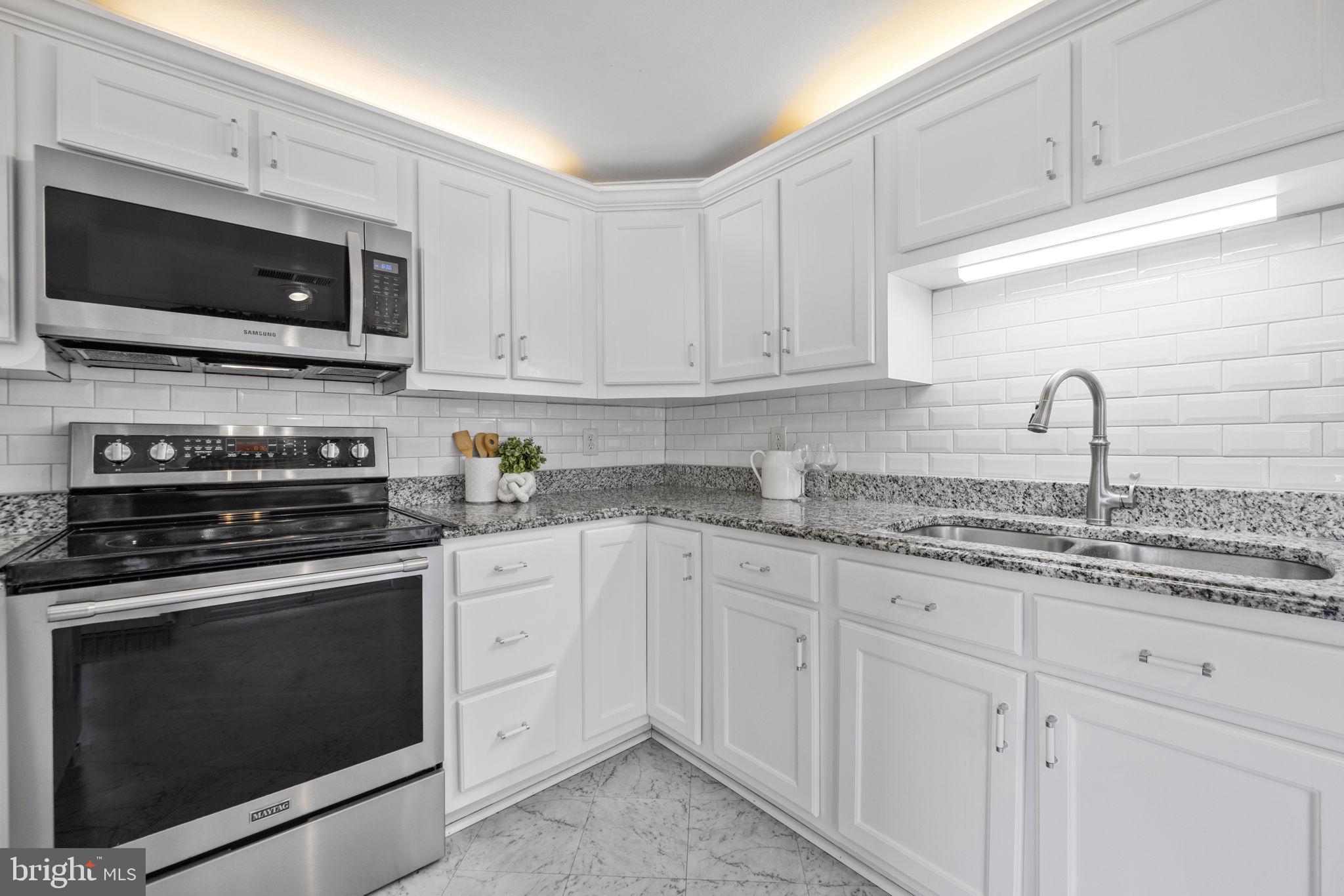 21315 Ridge Road Freeland, MD 21053 - Photo 20 of 69 a kitchen with granite countertop white cabinets stainless steel appliances and sink