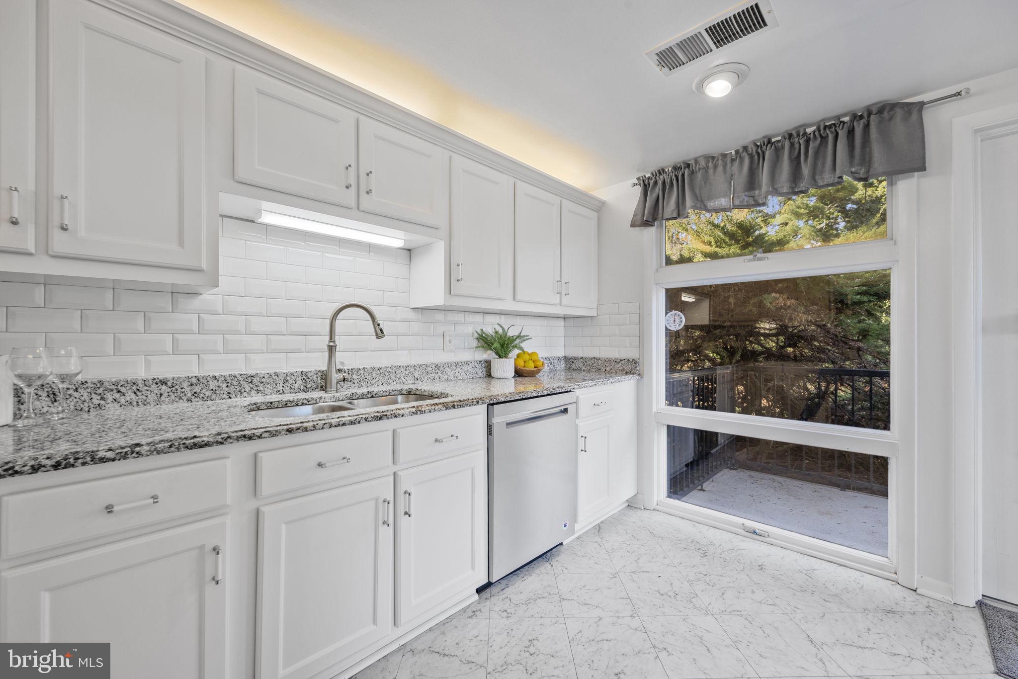 21315 Ridge Road Freeland, MD 21053 - Photo 22 of 69 a kitchen with granite countertop a sink window and cabinets