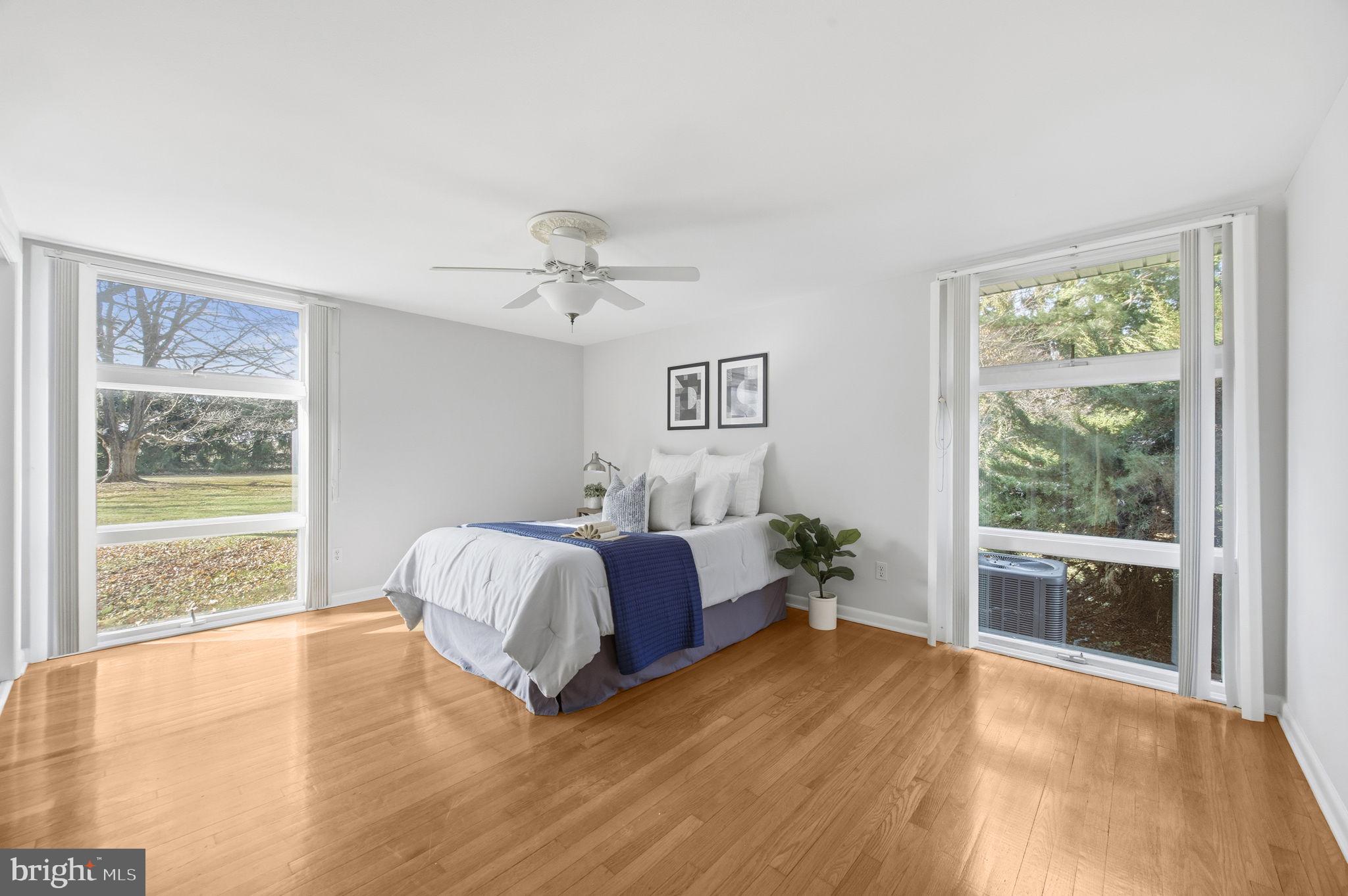21315 Ridge Road Freeland, MD 21053 - Photo 27 of 69 a spacious bedroom with a bed and wooden floor