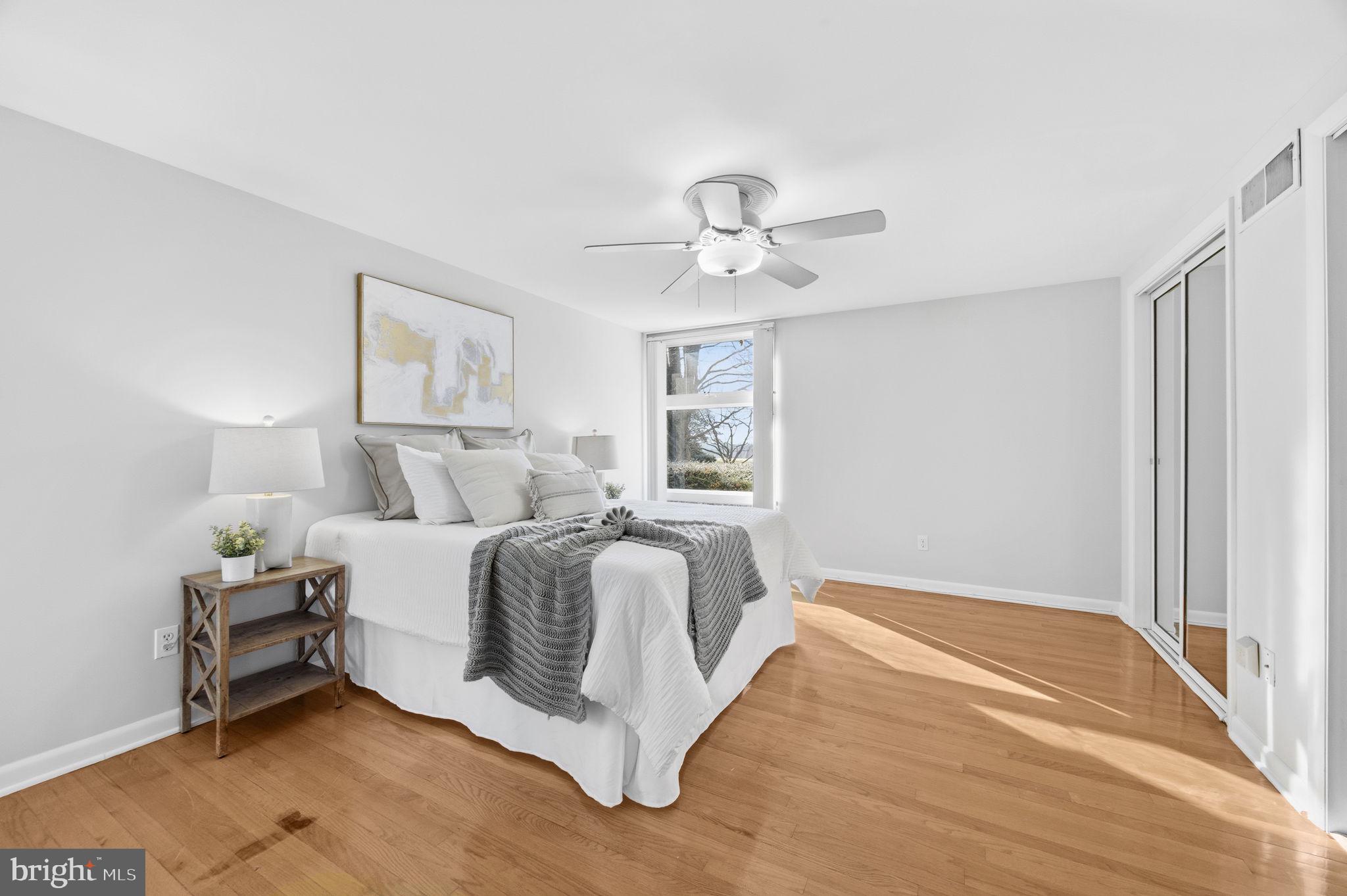21315 Ridge Road Freeland, MD 21053 - Photo 29 of 69 a spacious bedroom with a bed and a chandelier