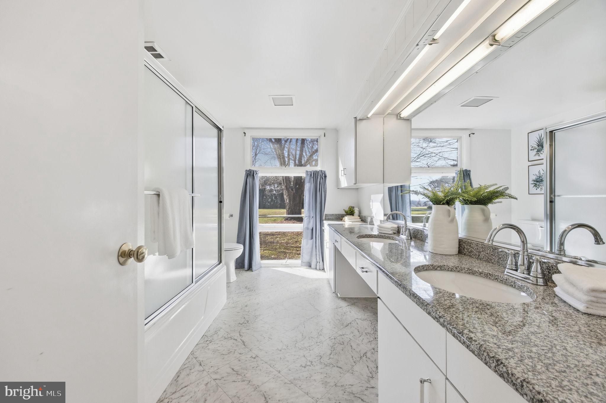21315 Ridge Road Freeland, MD 21053 - Photo 32 of 69 a bathroom with a granite countertop sink a mirror and shower