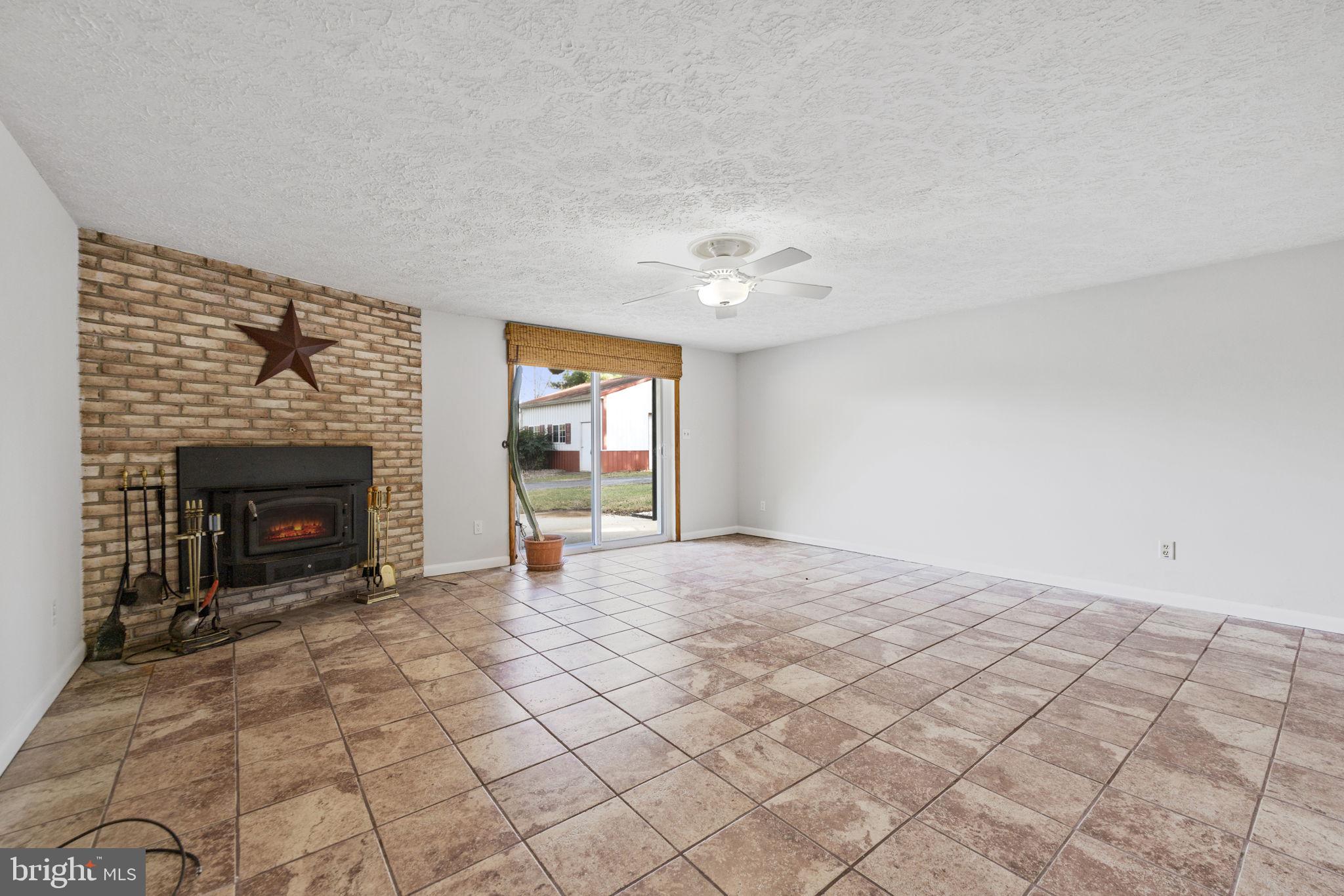 21315 Ridge Road Freeland, MD 21053 - Photo 36 of 69 a view of an empty room with window and fire place