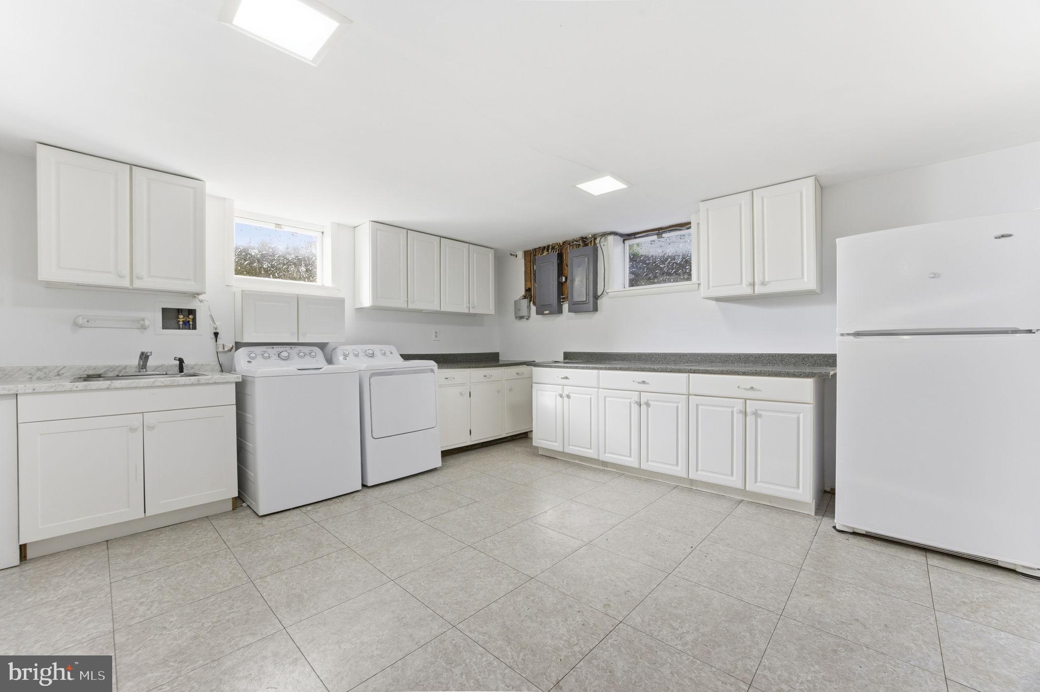 21315 Ridge Road Freeland, MD 21053 - Photo 42 of 69 a kitchen with white cabinets sink and white appliances