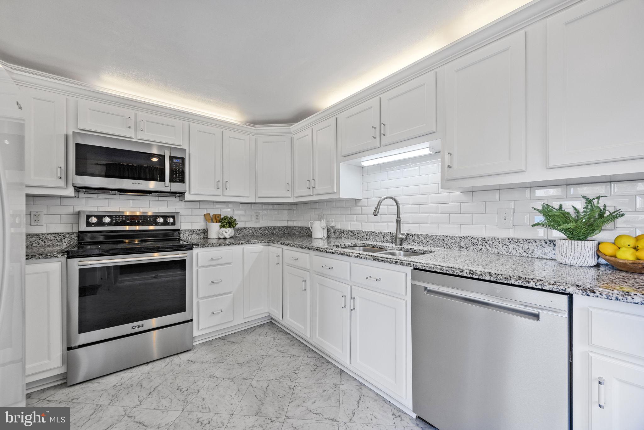 21315 Ridge Road Freeland, MD 21053 - Photo 5 of 69 a kitchen with granite countertop a sink stove and microwave