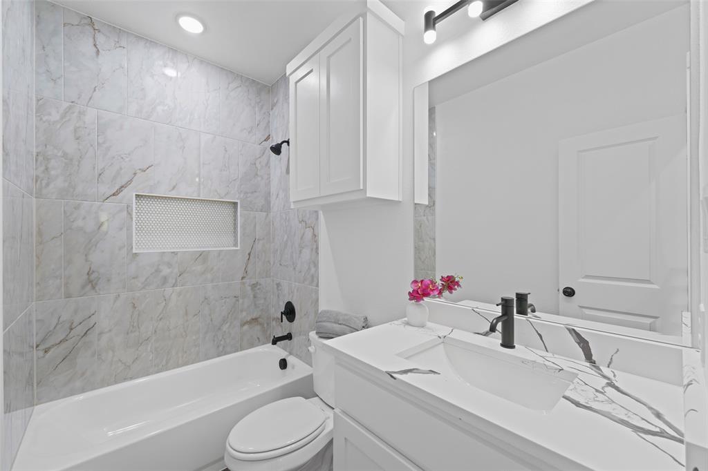 122 East Beachwood Loop Trinidad, TX 75163 - Photo 30 of 35 Bathroom featuring a white vanity with an integrated rectangular sink, a black single-handle faucet, and a large mirror