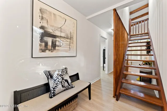 a view of an entryway with wooden floor