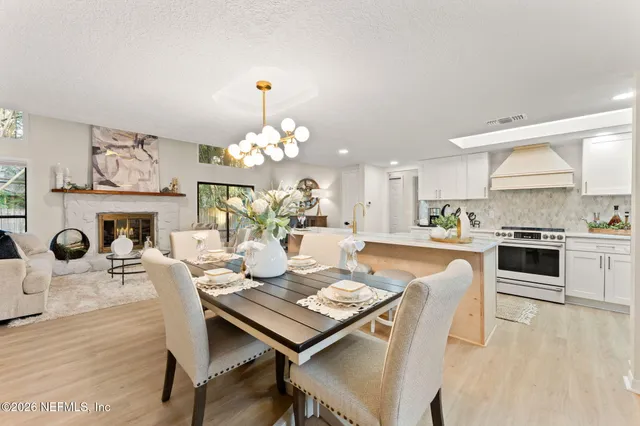 a living room with fireplace furniture and a table