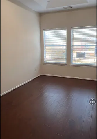 a view of yellow house with pool in front of it