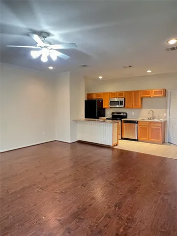 a view of a kitchen with a sink stainless steel appliances and cabinets