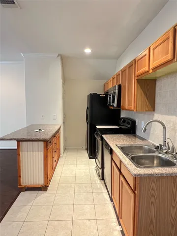 a kitchen with stainless steel appliances granite countertop a sink and a stove