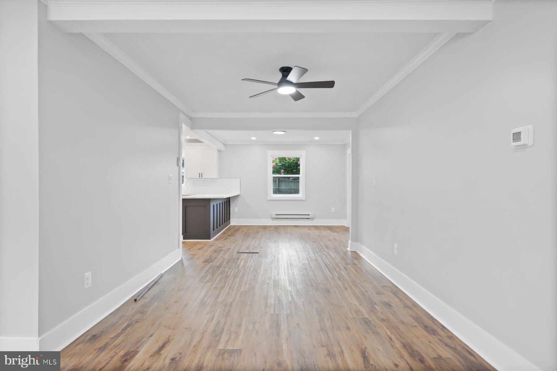 5915 Johnnycake Road Gwynn Oak, MD 21207 - Photo 10 of 35 wooden floor in an empty room with a window