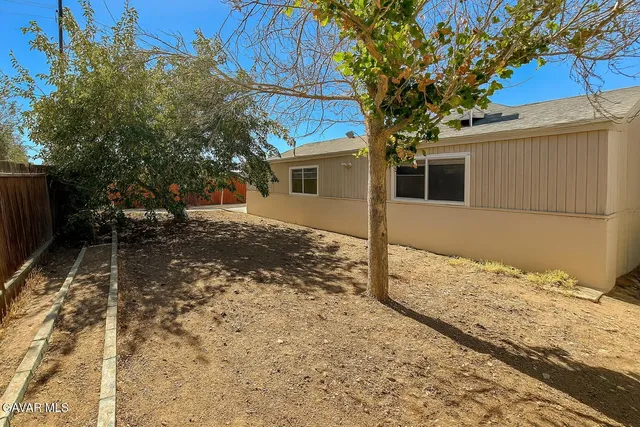 a view of a house with snow on the road