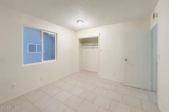 a view of an empty room with windows