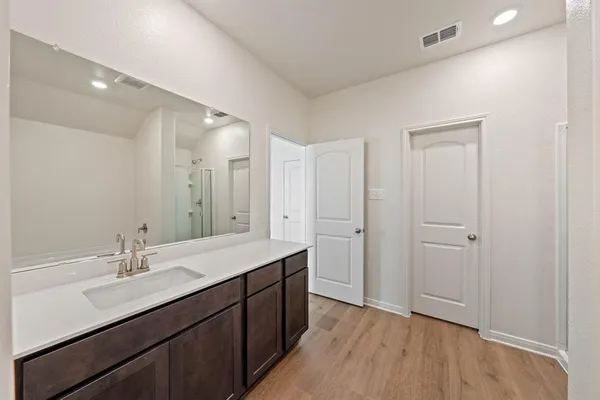 a bathroom with a sink mirror and a shower