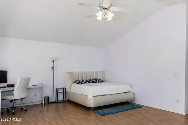 a large bed sitting in a bedroom next to a window