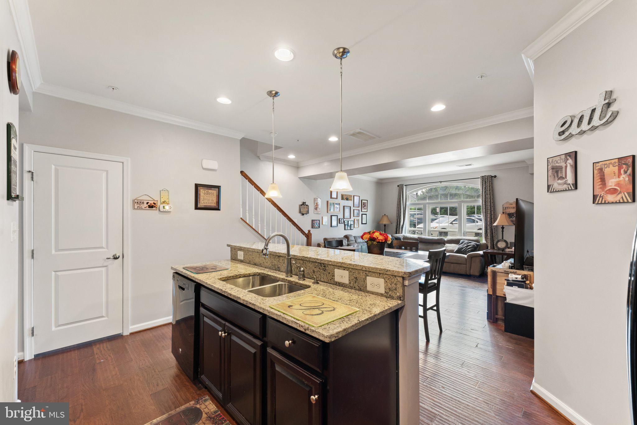 7494 Brunson Circle Gainesville, VA 20155 - Photo 12 of 49 a kitchen with a stove a refrigerator and a dining table with wooden floor