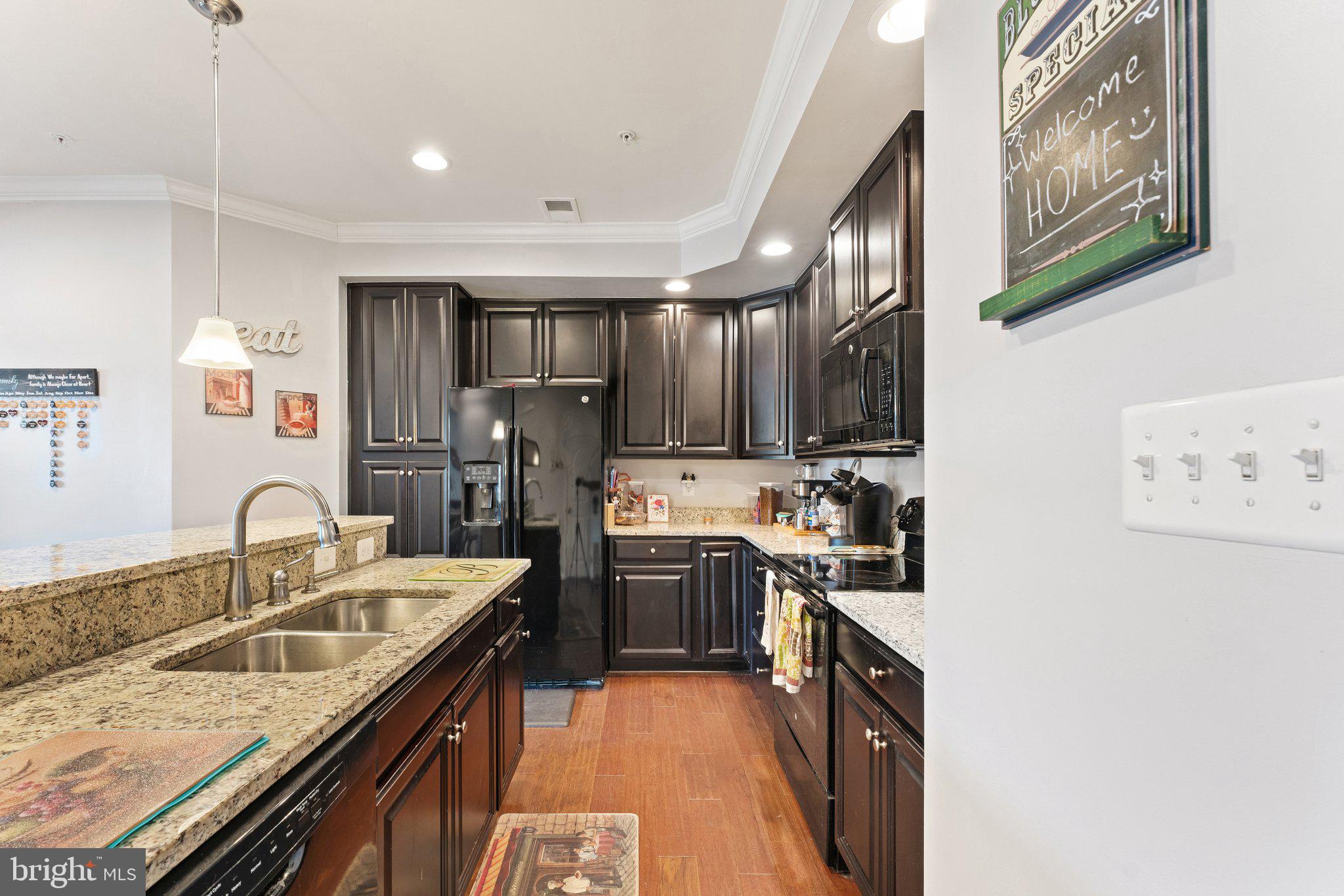 7494 Brunson Circle Gainesville, VA 20155 - Photo 13 of 49 a kitchen with stainless steel appliances granite countertop a sink stove and refrigerator