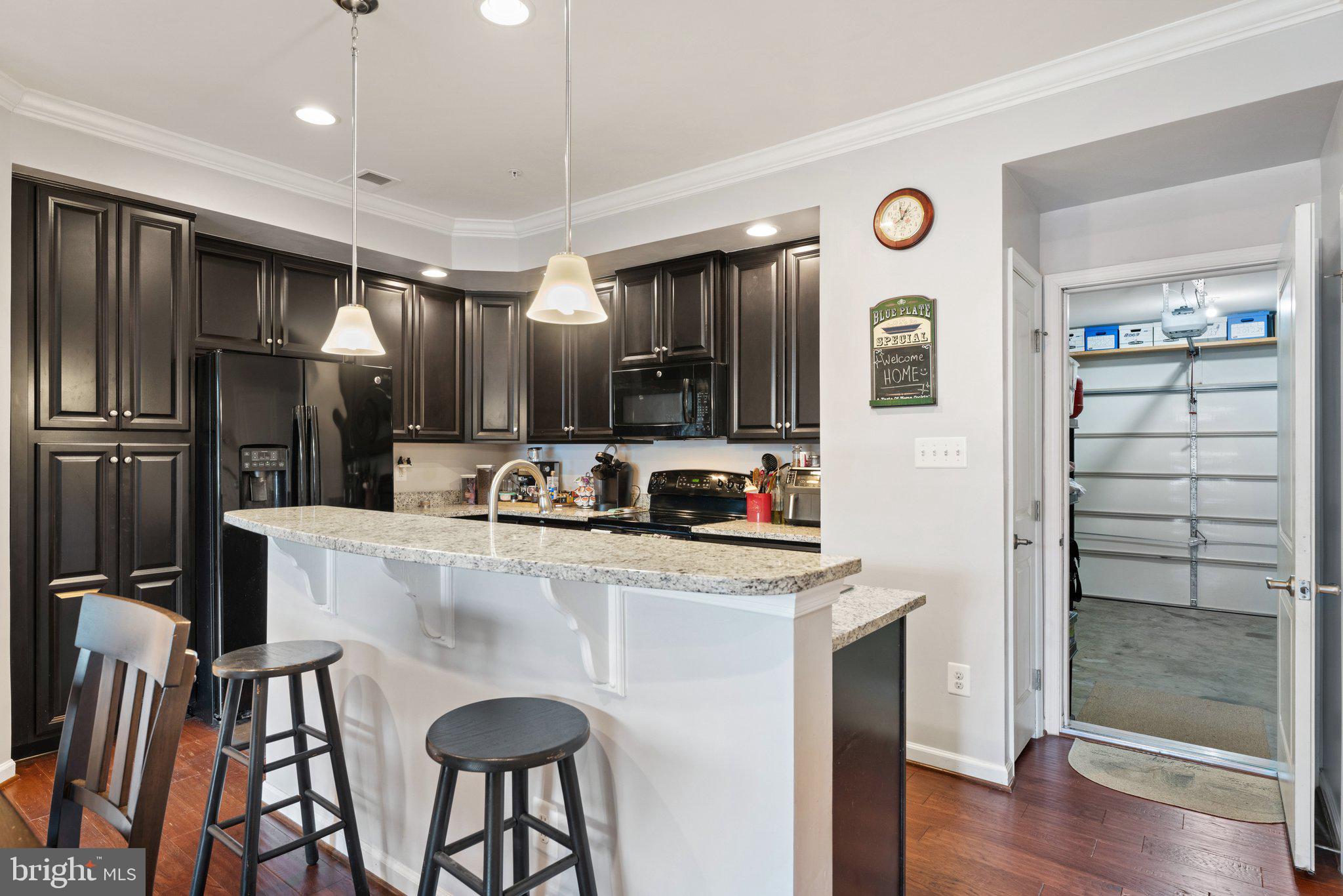 7494 Brunson Circle Gainesville, VA 20155 - Photo 14 of 49 a kitchen with kitchen island a counter top space stainless steel appliances and cabinets
