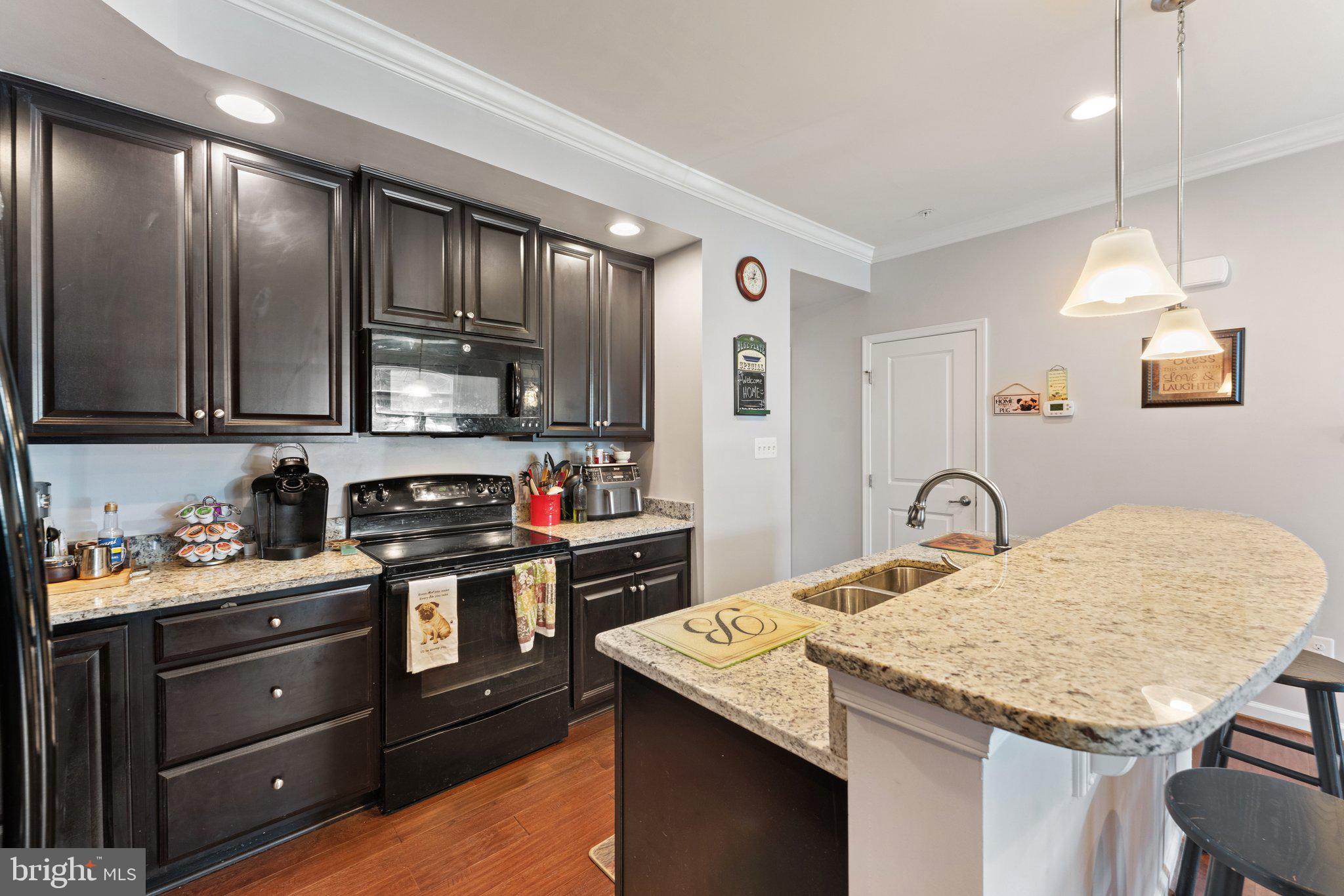 7494 Brunson Circle Gainesville, VA 20155 - Photo 17 of 49 a kitchen with a stove a sink and a refrigerator