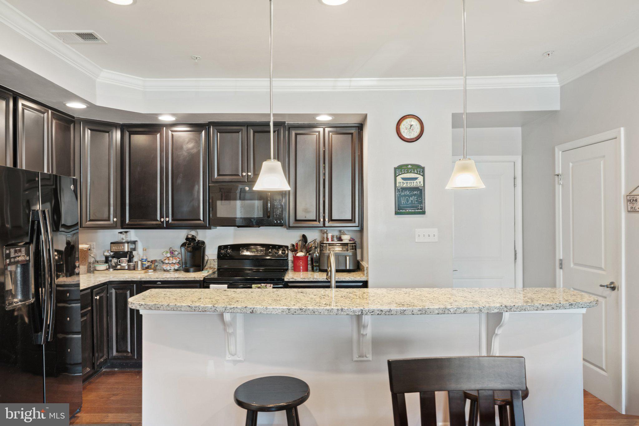 7494 Brunson Circle Gainesville, VA 20155 - Photo 19 of 49 a kitchen with a sink cabinets and window
