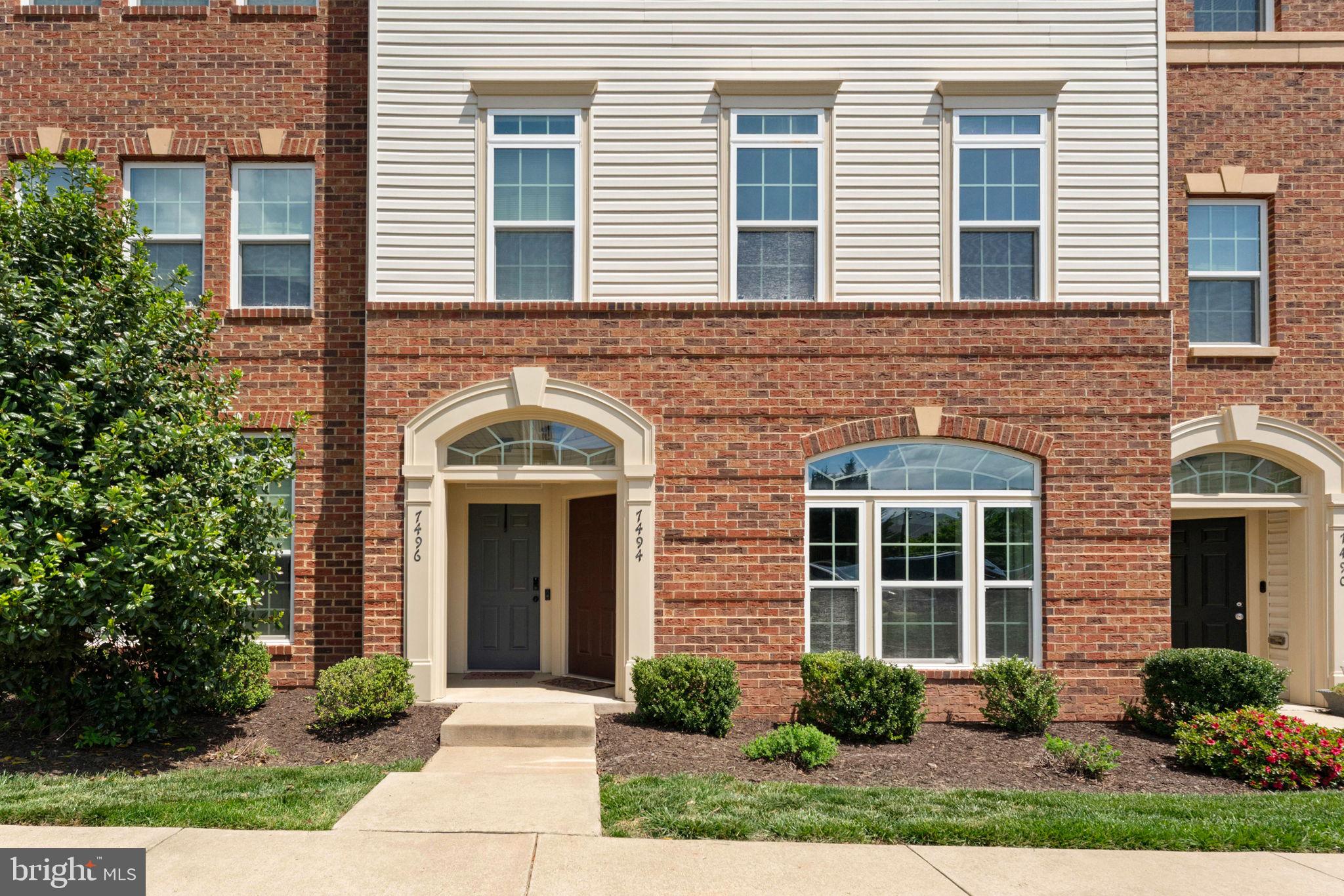 7494 Brunson Circle Gainesville, VA 20155 - Photo 2 of 49 a front view of a house with garden