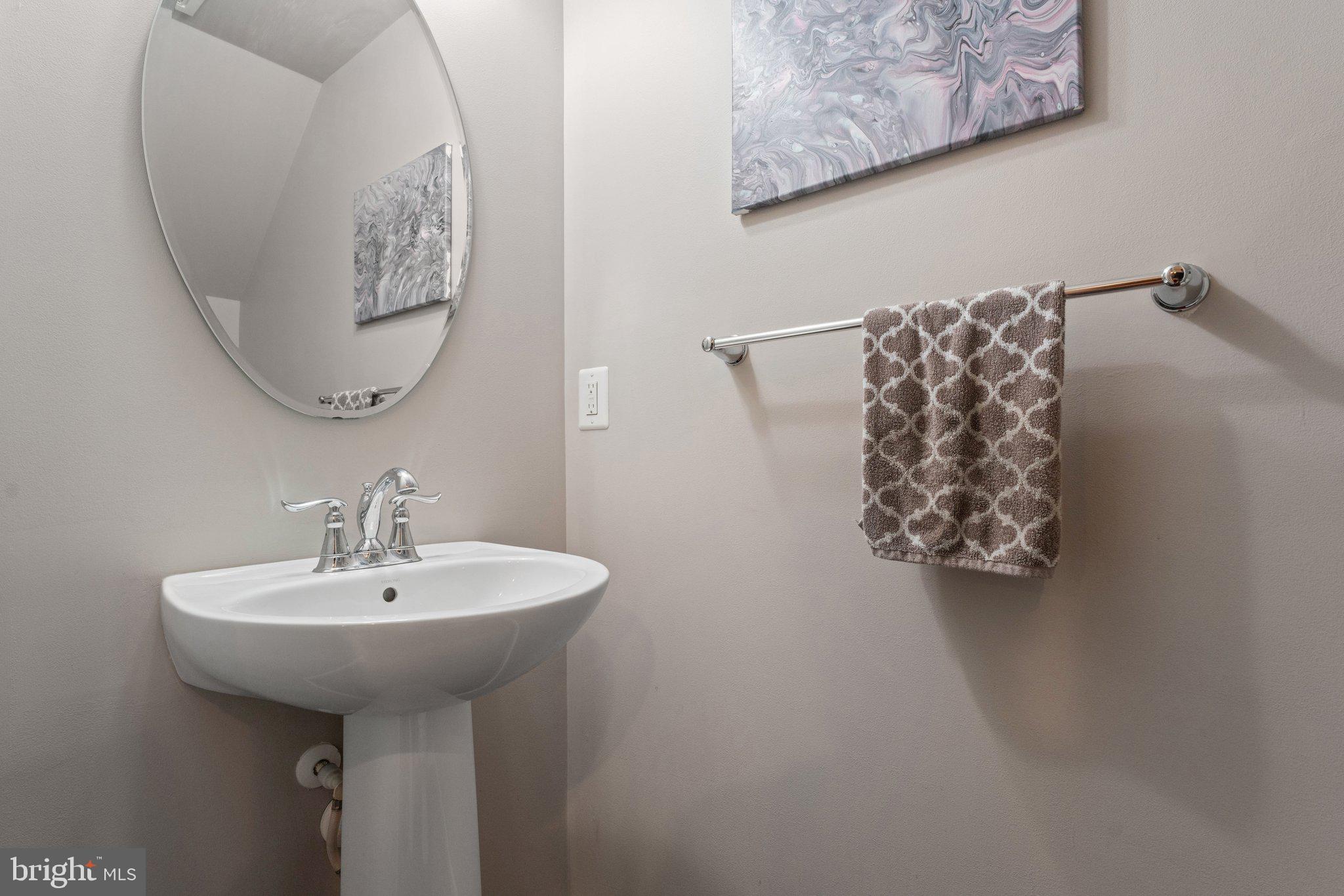 7494 Brunson Circle Gainesville, VA 20155 - Photo 21 of 49 a bathroom with a sink and a mirror