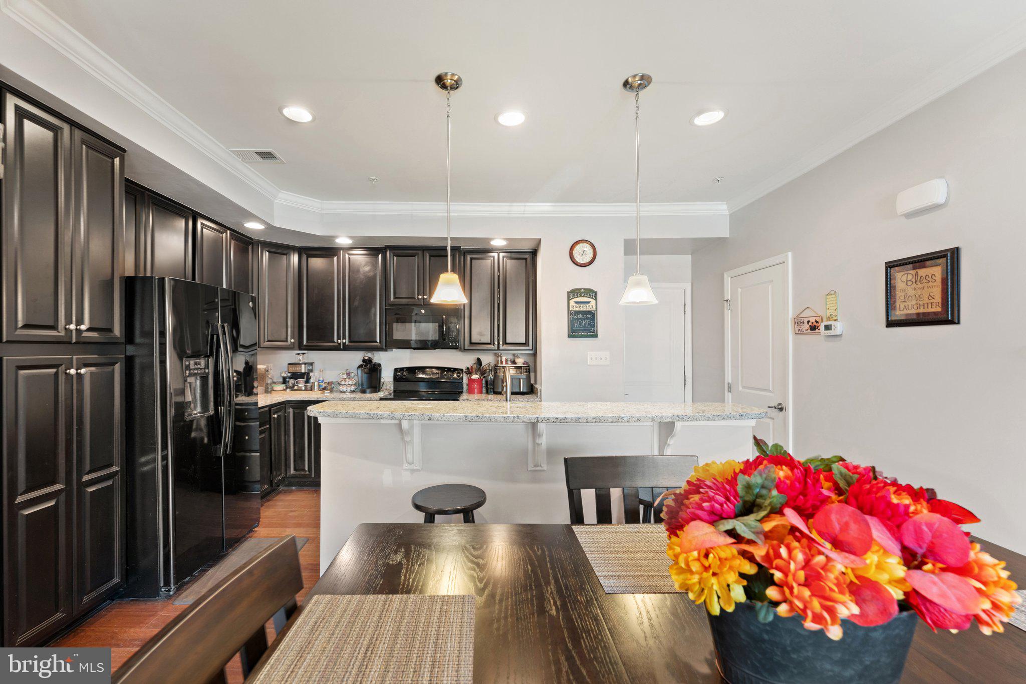 7494 Brunson Circle Gainesville, VA 20155 - Photo 23 of 49 a kitchen with stainless steel appliances kitchen island granite countertop a refrigerator and stove