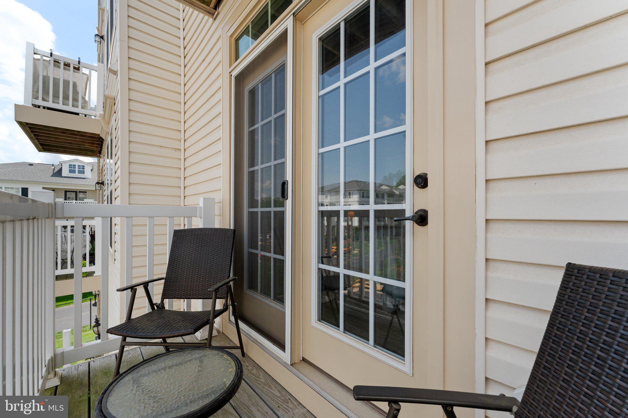 7494 Brunson Circle Gainesville, VA 20155 - Photo 35 of 49 a view of balcony with chair and tables