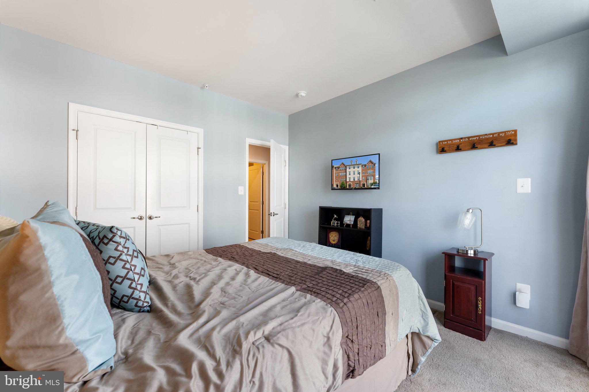 7494 Brunson Circle Gainesville, VA 20155 - Photo 36 of 49 a bedroom with a bed and a potted plant