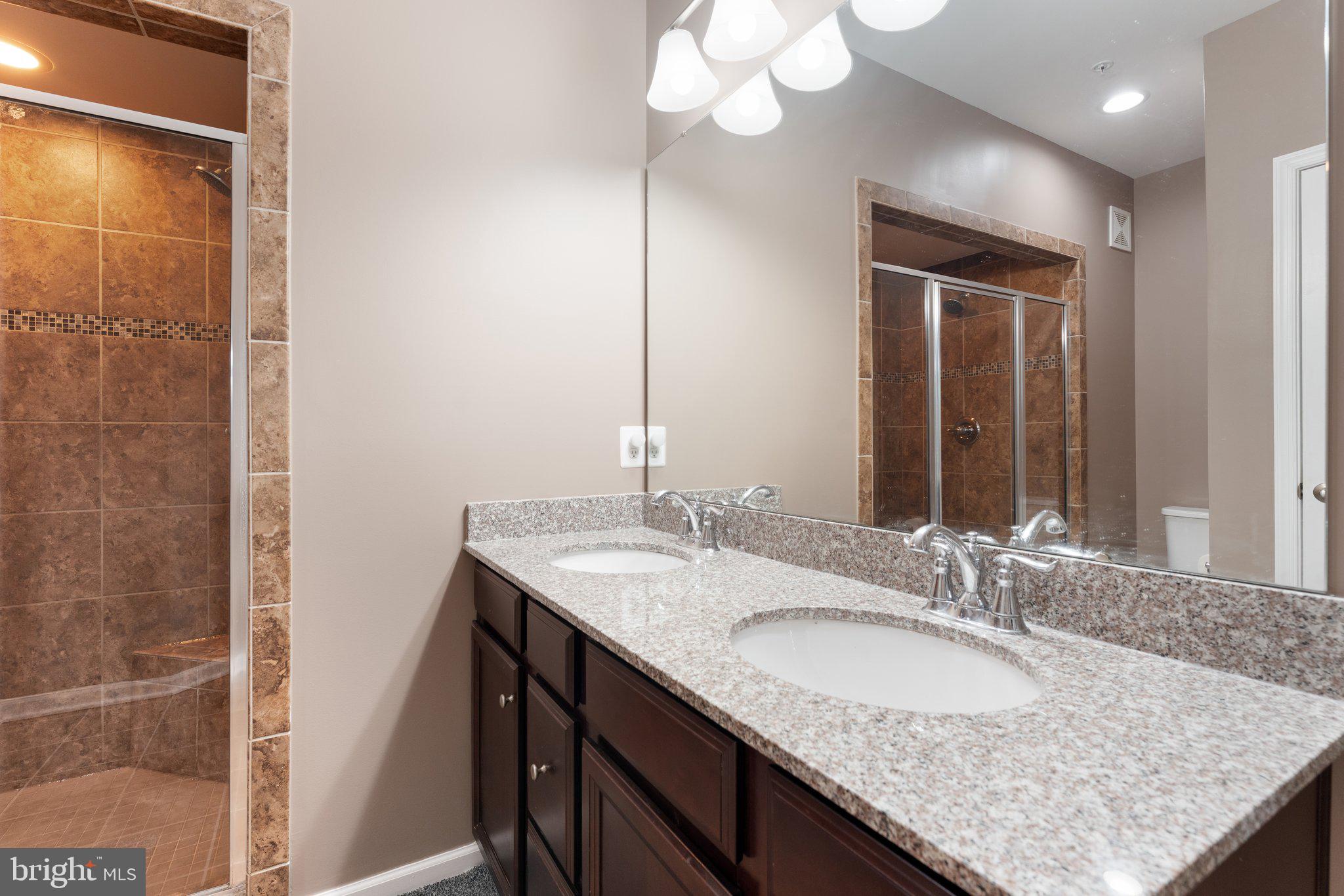 7494 Brunson Circle Gainesville, VA 20155 - Photo 48 of 49 a bathroom with a granite countertop sink and a mirror