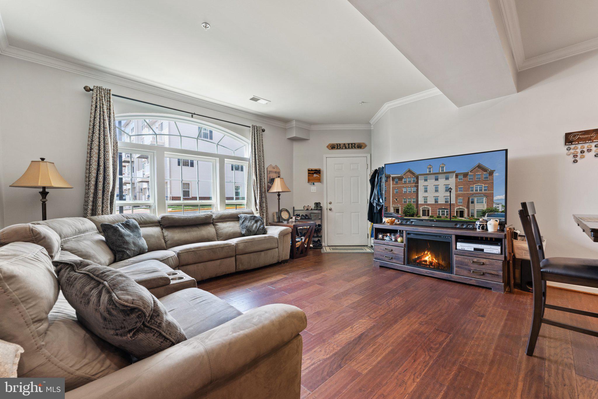7494 Brunson Circle Gainesville, VA 20155 - Photo 5 of 49 a living room with furniture and a flat screen tv with wooden floor