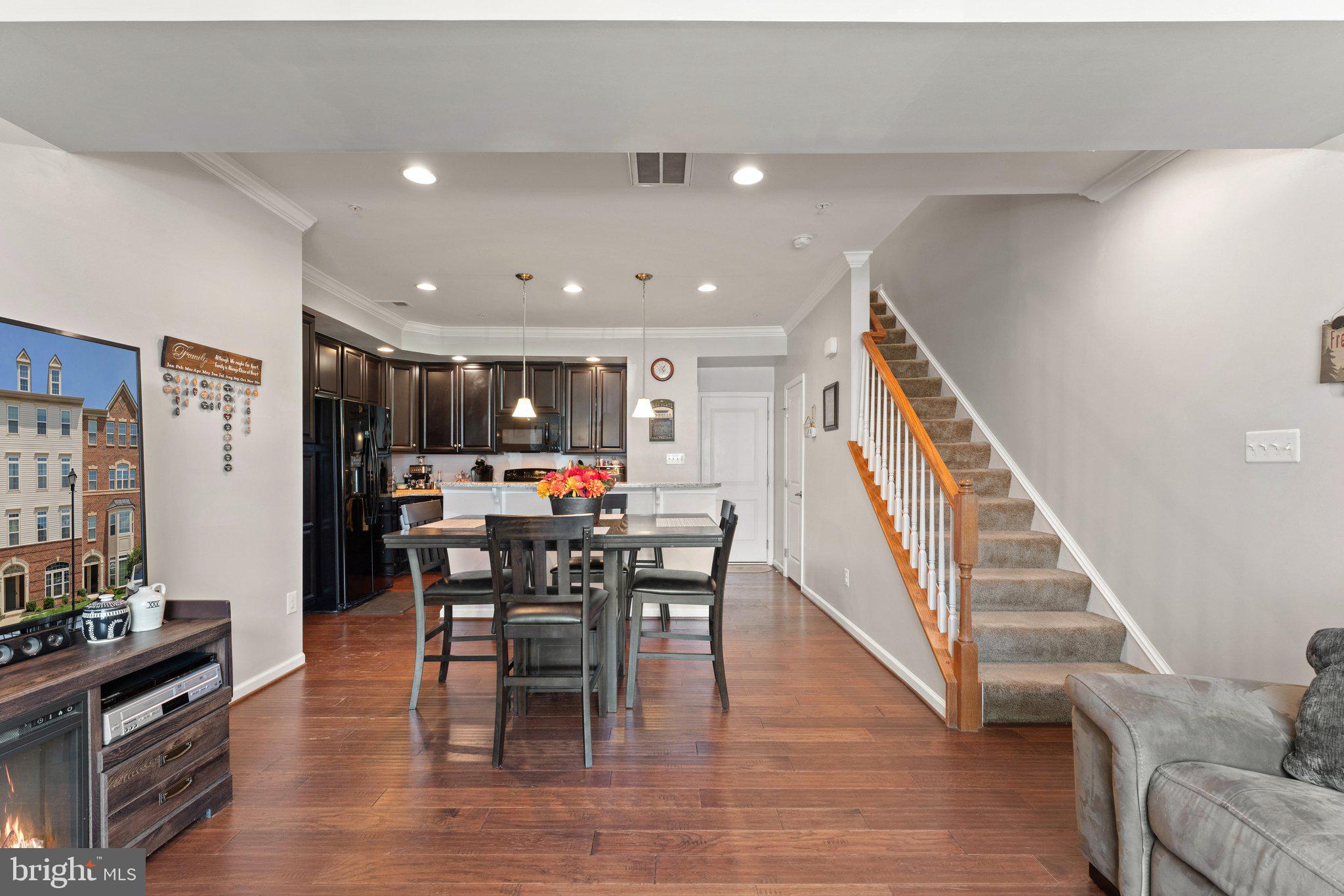 7494 Brunson Circle Gainesville, VA 20155 - Photo 8 of 49 a view of a dining room with furniture and wooden floor
