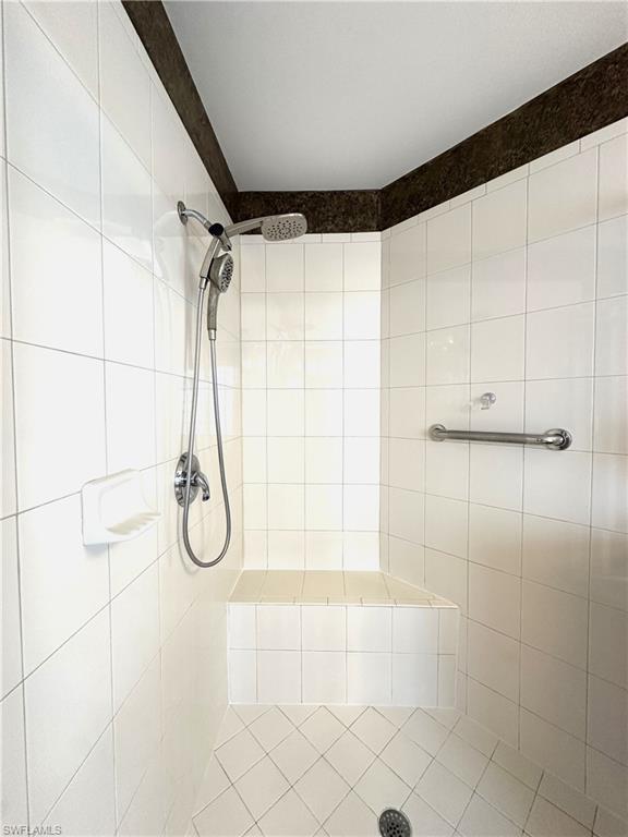 1357 Triandra Lane Naples, FL 34119 - Photo 17 of 40 a bathroom with a shower and a glass door