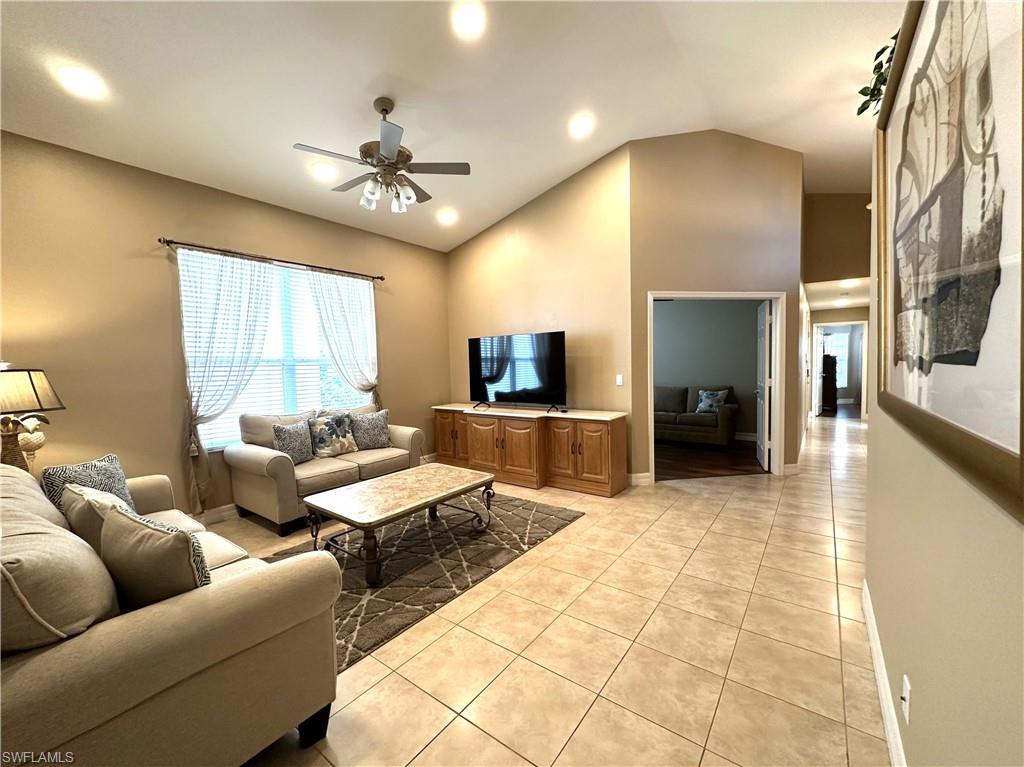 1357 Triandra Lane Naples, FL 34119 - Photo 19 of 40 a living room with furniture and a flat screen tv