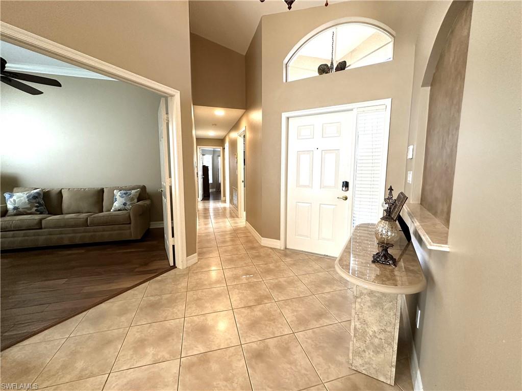 1357 Triandra Lane Naples, FL 34119 - Photo 20 of 40 a living room with furniture and a mirror