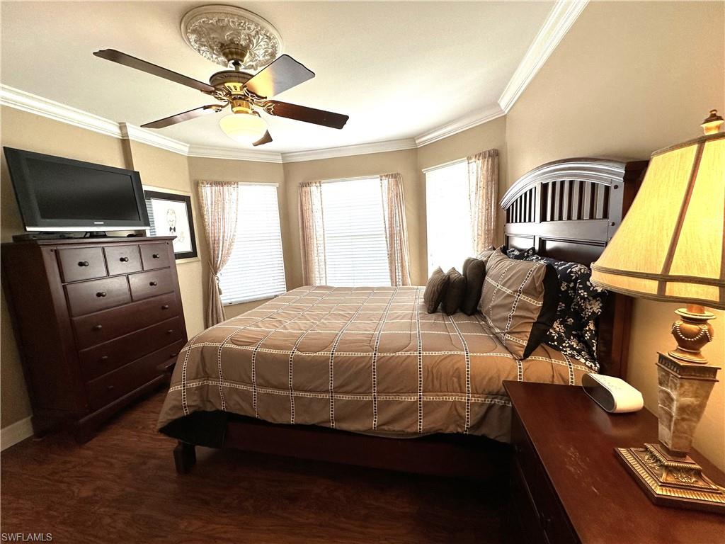 1357 Triandra Lane Naples, FL 34119 - Photo 24 of 40 a bedroom with a bed and a flat screen tv