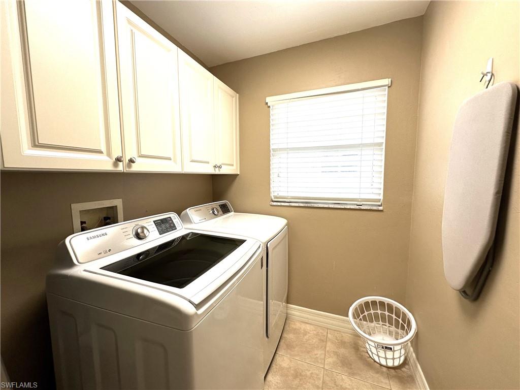 1357 Triandra Lane Naples, FL 34119 - Photo 26 of 40 a kitchen with a stove a sink and a window