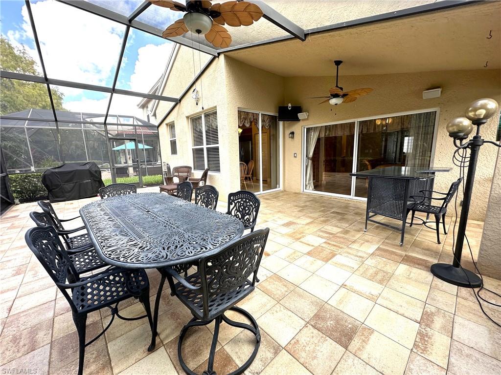 1357 Triandra Lane Naples, FL 34119 - Photo 29 of 40 a outdoor dining space with furniture and window