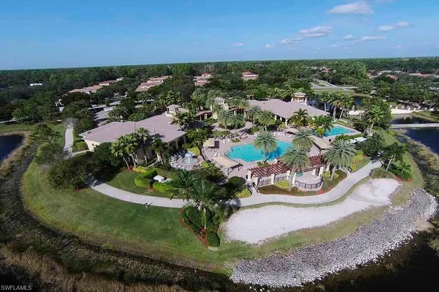 an aerial view of a house with a garden and lake view