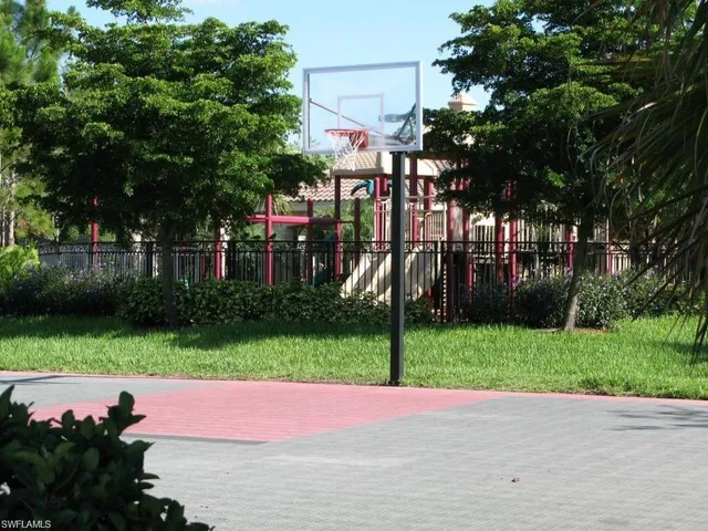 a street sign on a sidewalk next to a road