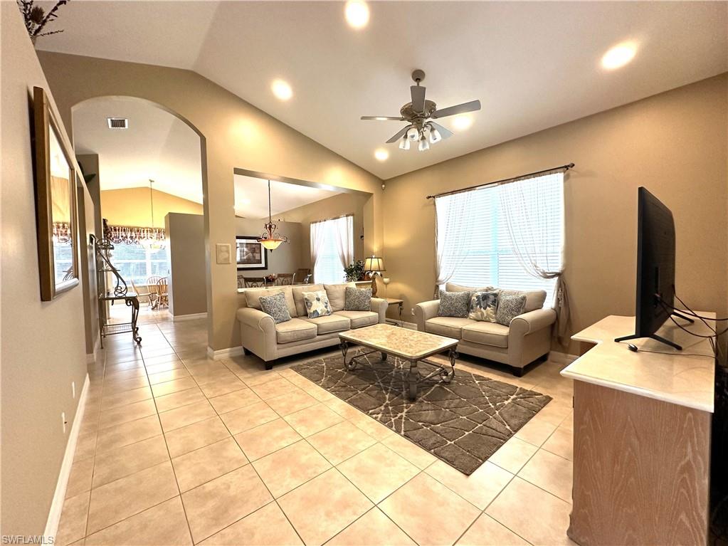 1357 Triandra Lane Naples, FL 34119 - Photo 6 of 40 a living room with furniture and a flat screen tv