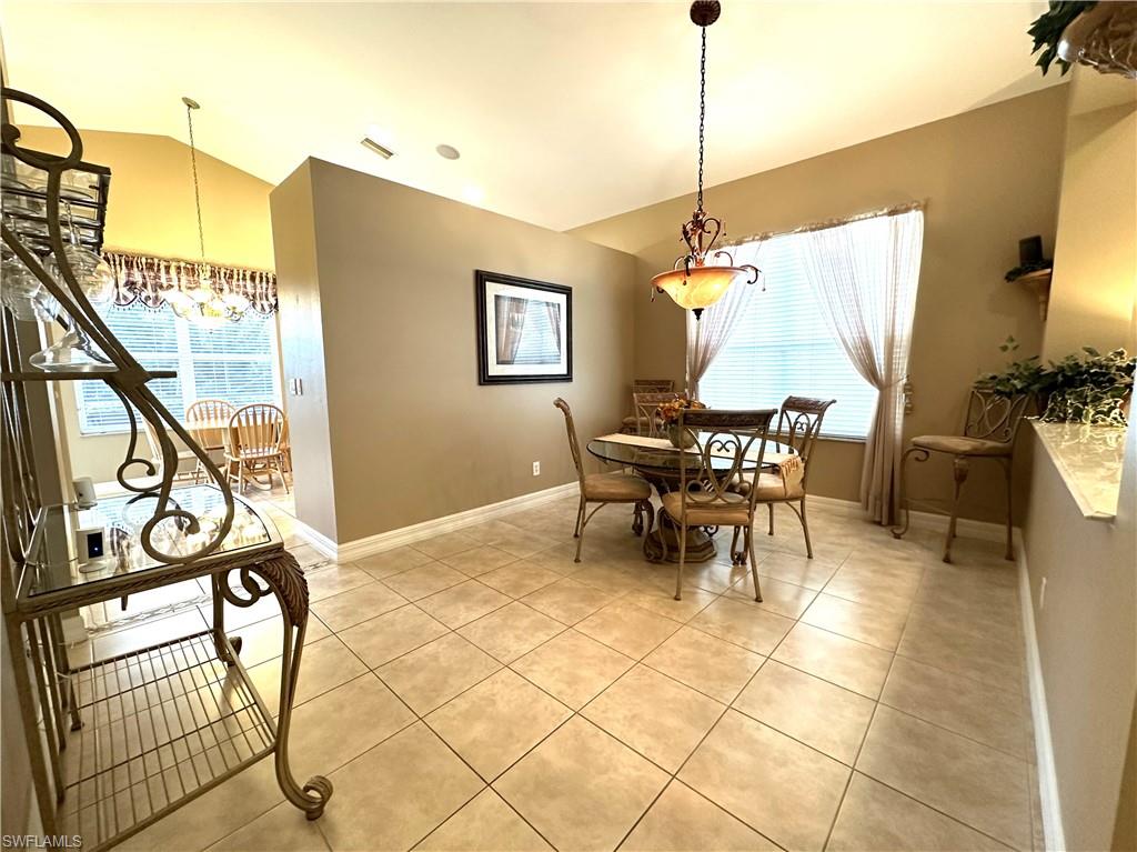 1357 Triandra Lane Naples, FL 34119 - Photo 8 of 40 a dining room with furniture and a window