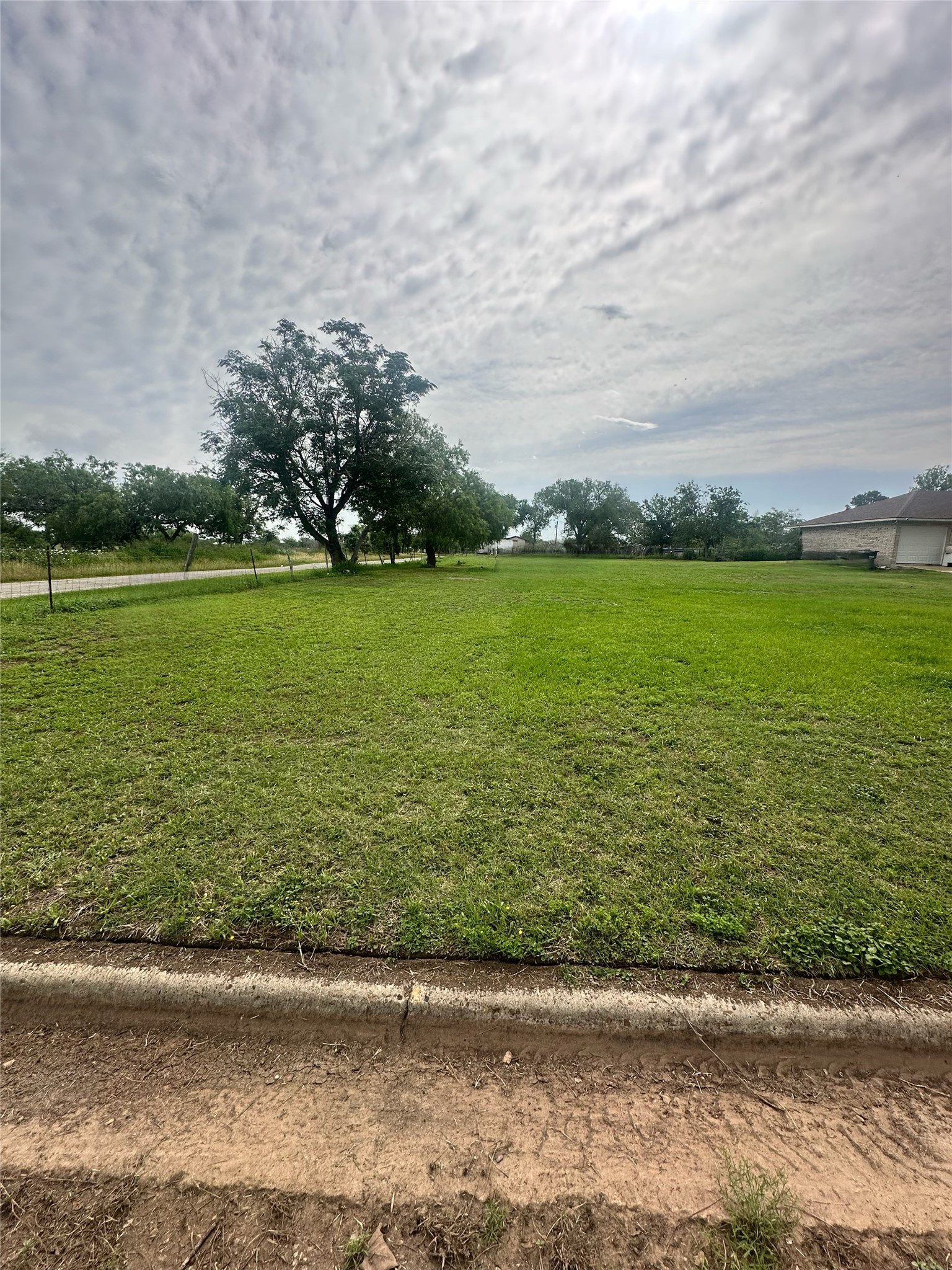 Tbd Fischer Street Cuero, TX 77954 - Photo 2 of 2 a view of a lake with a yard
