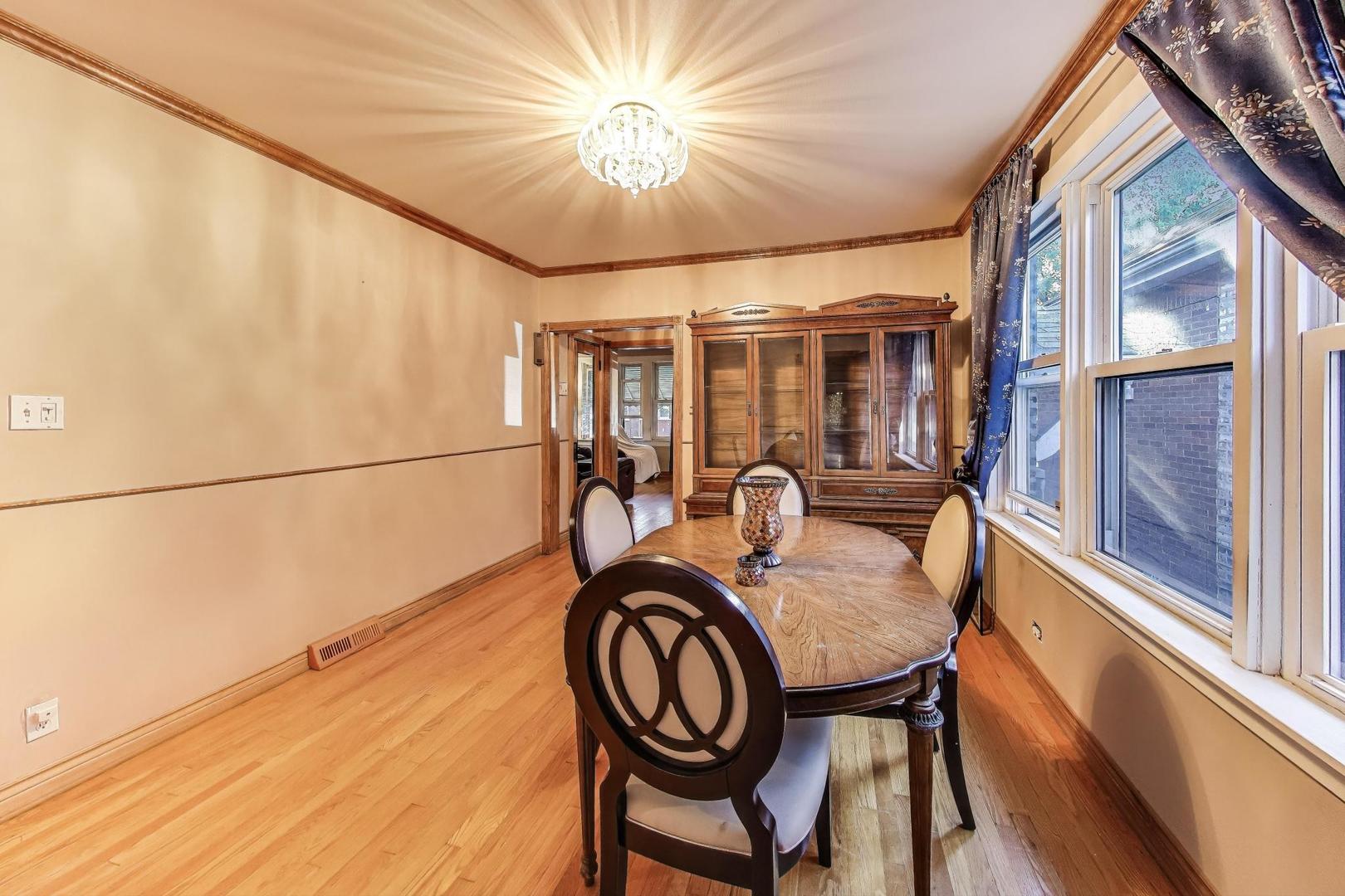 8346 South Aberdeen Street Chicago, IL 60620 - Photo 11 of 26 a dining room with furniture and chandelier