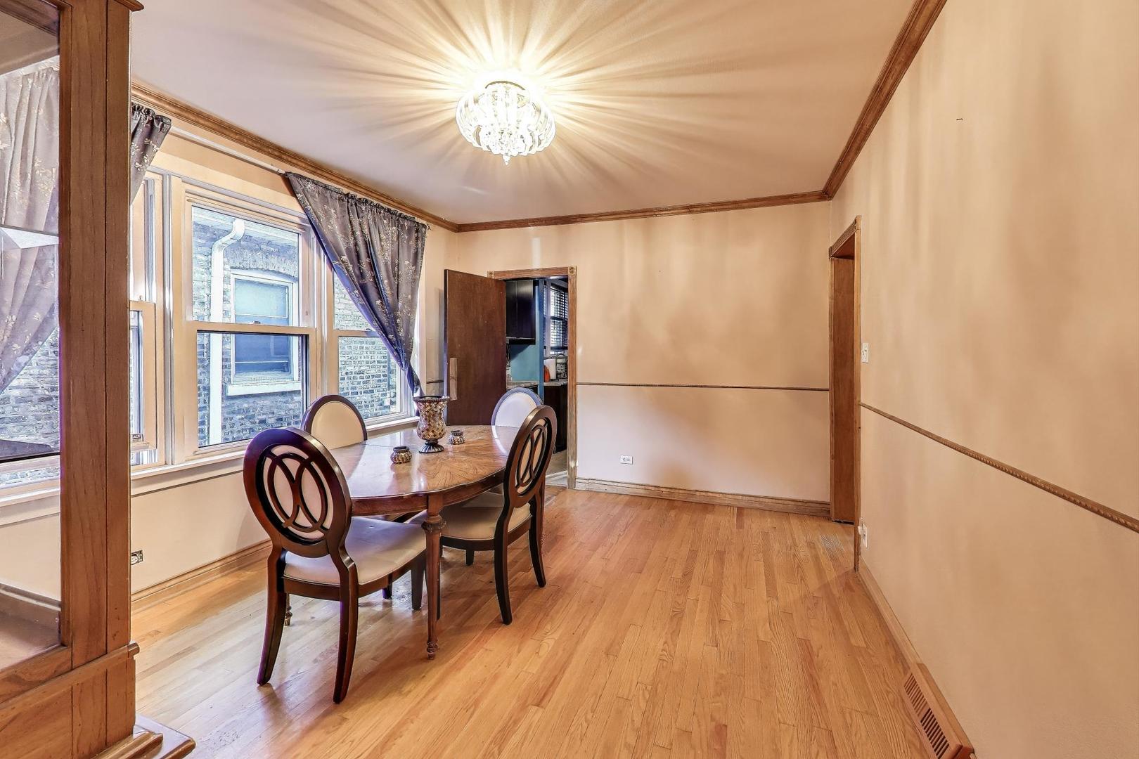 8346 South Aberdeen Street Chicago, IL 60620 - Photo 12 of 26 a view of a dining room with furniture wooden floor and chandelier